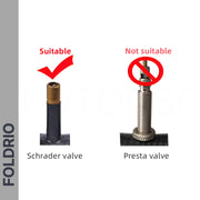 Image shows two bicycle valves: Schrader (with a red check mark, fitted with FOLDRIO Brompton Union Jack Valve Caps – Schrader) and Presta (with a red cross). “FOLDRIO” appears on the left.