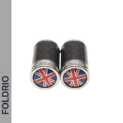 Two black and silver FOLDRIO Brompton Union Jack Valve Caps (Schrader, A/C/G Line) featuring the UK flag on one end are side by side on a white background, with “FOLDRIO” shown vertically along the left edge.