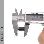 A digital caliper measures a Brompton Union Jack Valve Cap – Schrader (A/C/G Line) from FOLDRIO, showing 17.4 mm on the display. The brand name FOLDRIO appears vertically on the image’s left side.