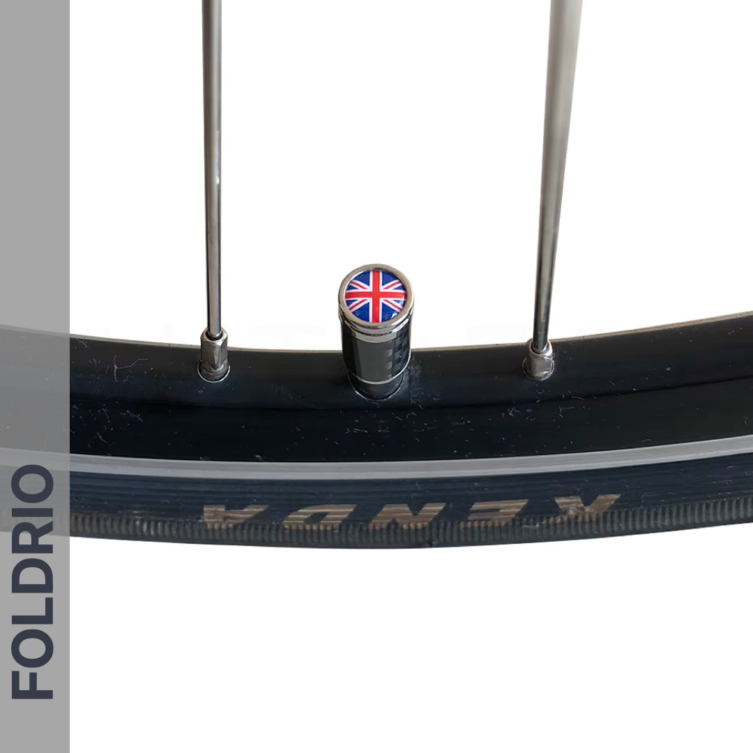 Close-up of a Brompton Union Jack Valve Cap by FOLDRIO (Schrader, A/C/G Line) on a bicycle wheel—ideal for those after stylish and unique Brompton valve accessories.