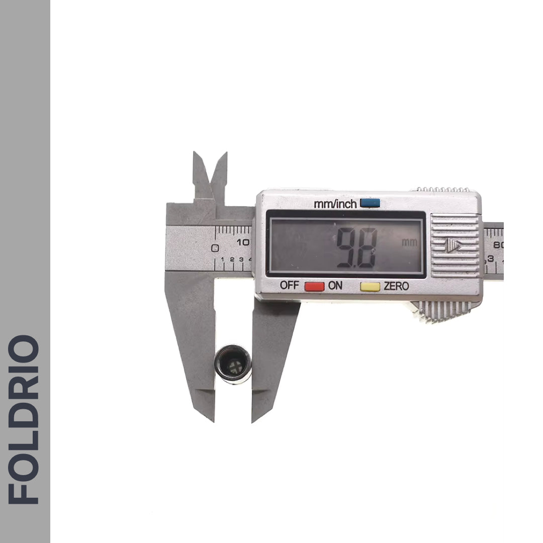 A digital caliper measures a Brompton Union Jack Valve Cap – Schrader (A/C/G Line), showing 9.8 mm on the screen. The left side has a vertical gray bar with "FOLDRIO" in bold capital letters.