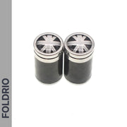 Two black cylindrical containers with metallic lids featuring a monochrome Union Jack are shown side by side. Ideal for storing Brompton Union Jack Valve Caps – Schrader (A/C/G Line) by FOLDRIO, whose name appears vertically on the left.