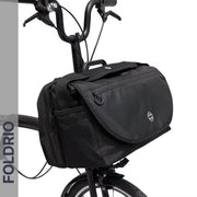Brompton Brompton S Bag in black with flap, circular logo, side pockets, and vertical “FOLDRIO” for front carrier block | Foldrio. Foldrio