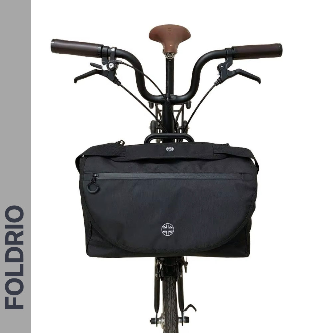 Brompton Brompton S Bag by Foldrio in black mounted on a bike with brown seat and handlebars, logo vertical on the left | Foldrio. Foldrio