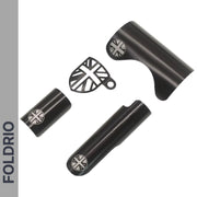 The FOLDRIO Brompton Frame Protector Set with British Flag is shown on a white background, featuring three black metal parts—including a rear fork cover and chainstay guard—each with a silver Union Jack bolt and FOLDRIO branding.