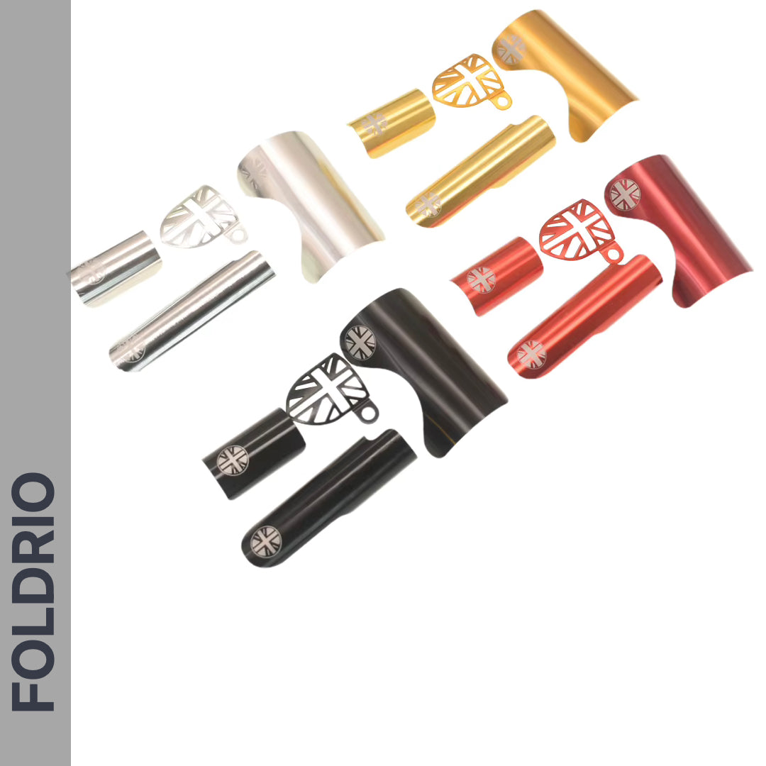 FOLDRIO Brompton Frame Protector Set with British Flag, assorted metallic clamps and levers in silver, gold, red, and black, displayed on white with the FOLDRIO name vertically on a gray sidebar.
