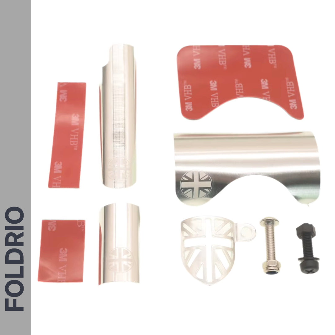 The FOLDRIO Brompton Frame Protector Set with British Flag includes adhesive strips, two metal plates featuring the emblem, a plastic piece, and two screws—perfect as a frame or chainstay guard. All items are arranged on a white background.