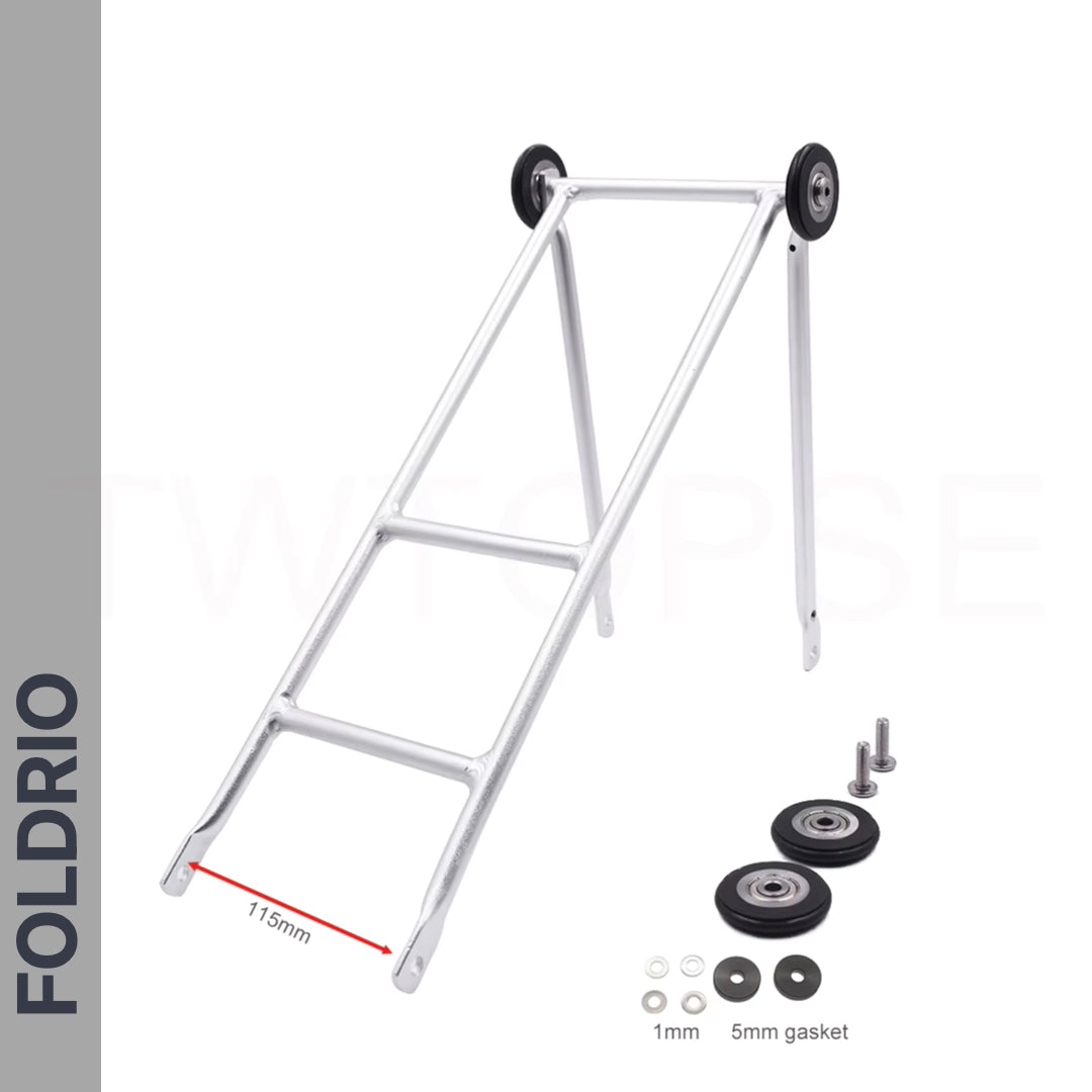 The Brompton Rear Rack – Lightweight Aluminium Cargo Rack is a silver, ultralight aluminium folding rack with two black wheels at the top. Shown angled, it includes easywheel mounts, screws, 1mm/5mm gaskets; lower bar spacing: 115mm.