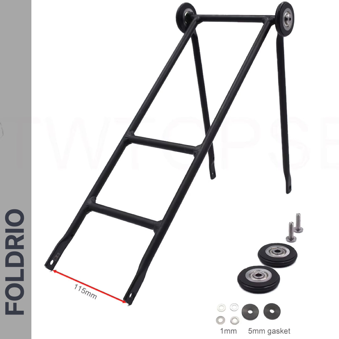 The Brompton Rear Rack – Lightweight Aluminium Cargo Rack features a black metal ultralight frame, two small wheels, hardware and washers. Red line marks 115mm rack base width. "FOLDRIO" appears vertically on the left side.