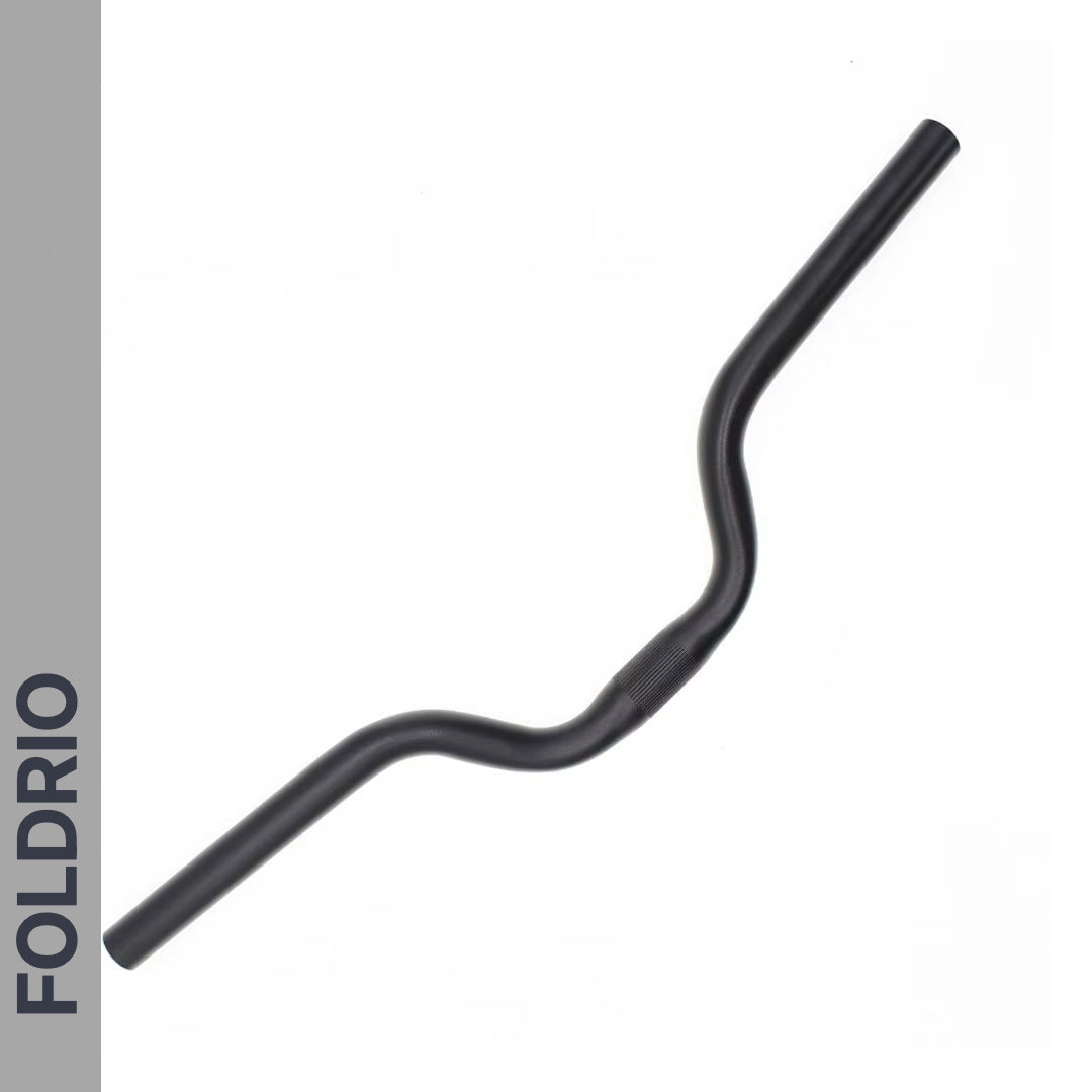 A Brompton M Handlebar in anodised aluminium, shown in black and designed for an upright riding position, is displayed on a white background. The word FOLDRIO appears vertically on a gray bar along the left edge.