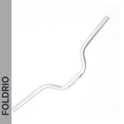 A Brompton M Handlebar – Anodised Aluminium, shown in silver with a gentle rise for upright riding, is placed diagonally on a white background. "FOLDRIO" appears vertically on a grey bar along the left side.