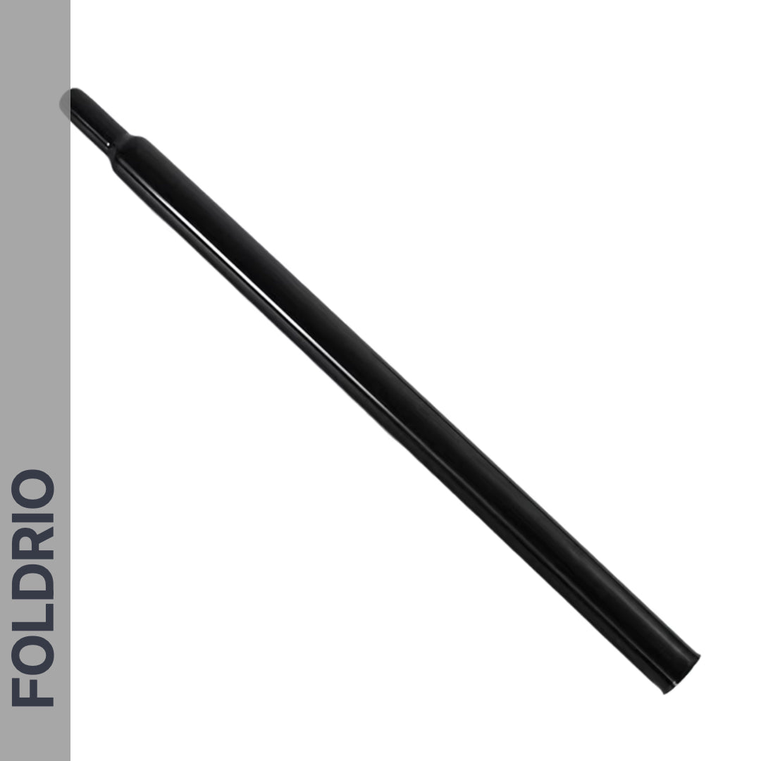 A long, black cylindrical metal tube (Brompton Titanium Seatpost – Lightweight Upgrade, 560mm & 580mm), diameter 31.8mm with a narrower end, lays diagonally on a white background. A gray strip on the left shows "FOLDRIO" in bold letters.