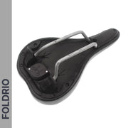A black bicycle saddle is shown upside down, showing its rails and the mounting hardware. A grey strip on the left reads “FOLDRIO.” Compatible with the Brompton AirTag Saddle Mount – Hidden Tracker Holder for enhanced security.