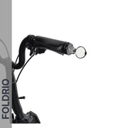 Close-up of a black bicycle handlebar fitted with the Brompton Bar End Mirror – 360° Adjustable, Foldable. "FOLDRIO" appears vertically on a gray strip at the left. The background is predominantly white.