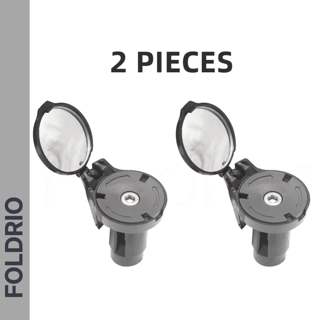 Two Brompton Bar End Mirrors—360° adjustable and foldable in black—are displayed side by side with open reflective lids on a white background. Large text above reads "2 PIECES," and the left gray bar shows "FOLDRIO.