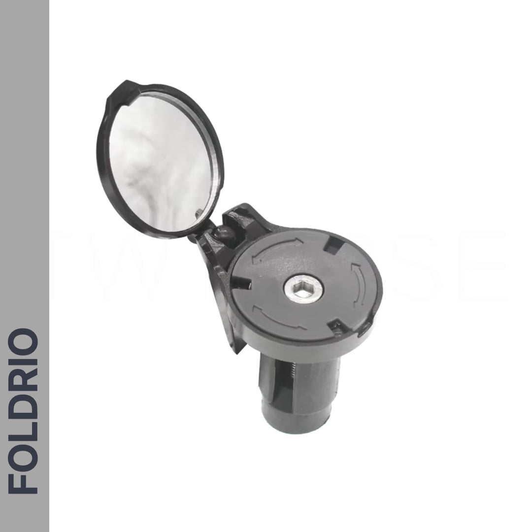 A Brompton Bar End Mirror – 360° Adjustable, Foldable, made of black plastic with a round hinged cap and reflective surface, is displayed open against a white background. "FOLDRIO" appears vertically on a gray sidebar.