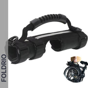 The Brompton Carry Handle & Shoulder Strap is a black portable handle with padded grip and adjustable straps, designed for carrying folded bikes. An inset image shows a person lifting a folded bike using the handle.