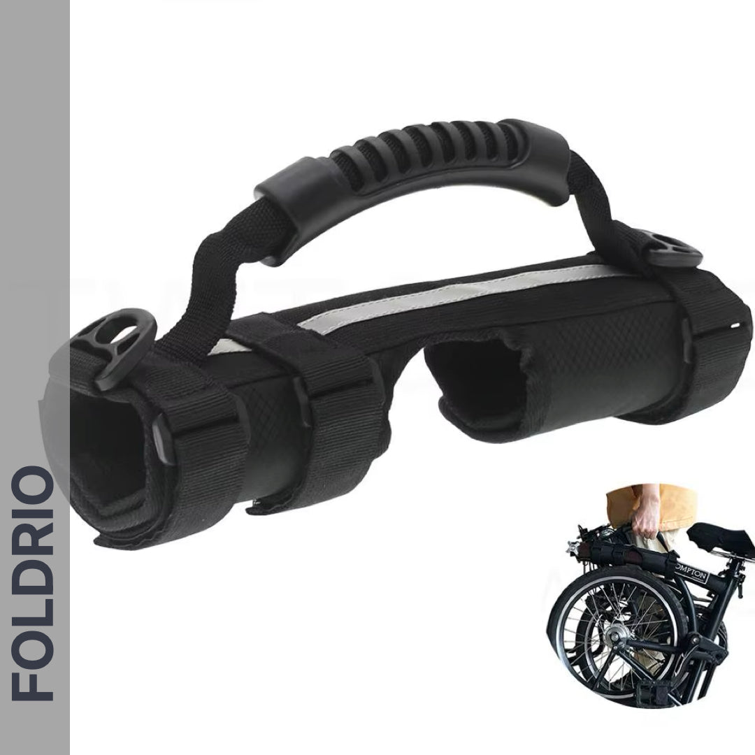 The Brompton Carry Handle & Shoulder Strap is a black portable handle with padded grip and adjustable straps, designed for carrying folded bikes. An inset image shows a person lifting a folded bike using the handle.