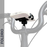 A close-up of a smartphone mounted horizontally on the lightweight Brompton Phone Mount – No Case Needed by FOLDRIO, with "FOLDRIO" vertically displayed on the left and a black handlebar in view.