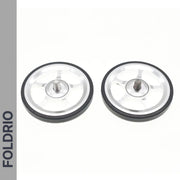 Two small silver Brompton Easy Wheels with titanium bolts, black rubber edges, and FOLDRIO branding are shown side by side on a white background, with the word FOLDRIO vertically on a gray strip to the left.