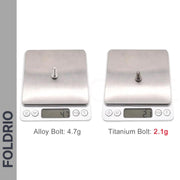 Two digital scales display FOLDRIO Brompton Easy Wheels with titanium bolts: the left shows an alloy bolt at 4.7g, the right a titanium bolt at just 2.1g—ultra-lightweight for bike wheels or as Brompton accessories. “FOLDRIO” is shown on the left side.