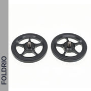 Two black, five-spoke Brompton Easy Wheels with titanium bolts by FOLDRIO are shown side by side on a white background. The brand name appears vertically on a gray strip to the left.