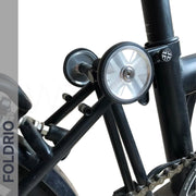 Close-up of a Brompton Easy Wheels Union Jack Edition with Titanium Bolts by FOLDRIO on a bicycle’s rear frame, showing the laser-engraved Union Jack detail and the FOLDRIO logo vertically on the left.