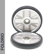 Two Brompton Easy Wheels Union Jack Edition by FOLDRIO, featuring titanium bolts, are shown on a white background. The word FOLDRIO is vertically displayed on a gray strip to the left.