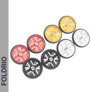 Eight Brompton Easy Wheels Union Jack Edition with titanium bolts by FOLDRIO, made from AL7075 aluminium in red, yellow, black, and silver. Arranged in two rows on a white background with "FOLDRIO" vertically on the left.