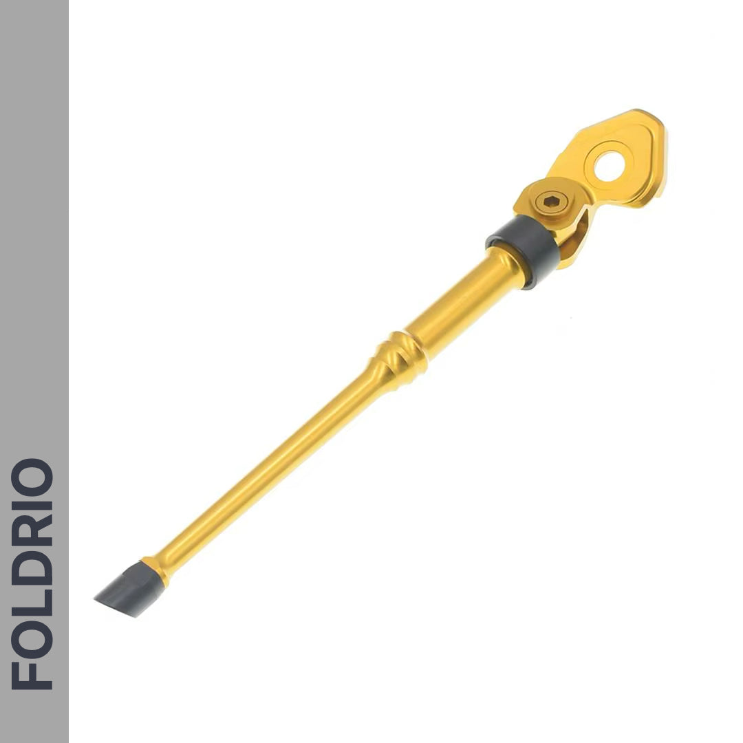 The FOLDRIO Brompton Kickstand – Adjustable Aluminium for A and C Line is shown with a gray rubber tip, rear axle mount, and mounting bracket on a white background with "FOLDRIO" vertically on a gray side panel.