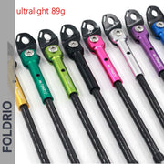 Several colorful Brompton kickstands by FOLDRIO, featuring black heads and ultralight 89g carbon fibre design, are lined up on a white background. "FOLDRIO" appears along the left, highlighting the P and T Line models’ minimal weight.