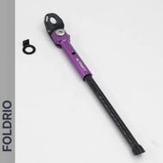 A FOLDRIO Brompton Kickstand – Carbon Fibre, P and T Line is shown on a white background with a black washer and bracket beside it. The brand name "FOLDRIO" appears vertically on a gray sidebar to the left.