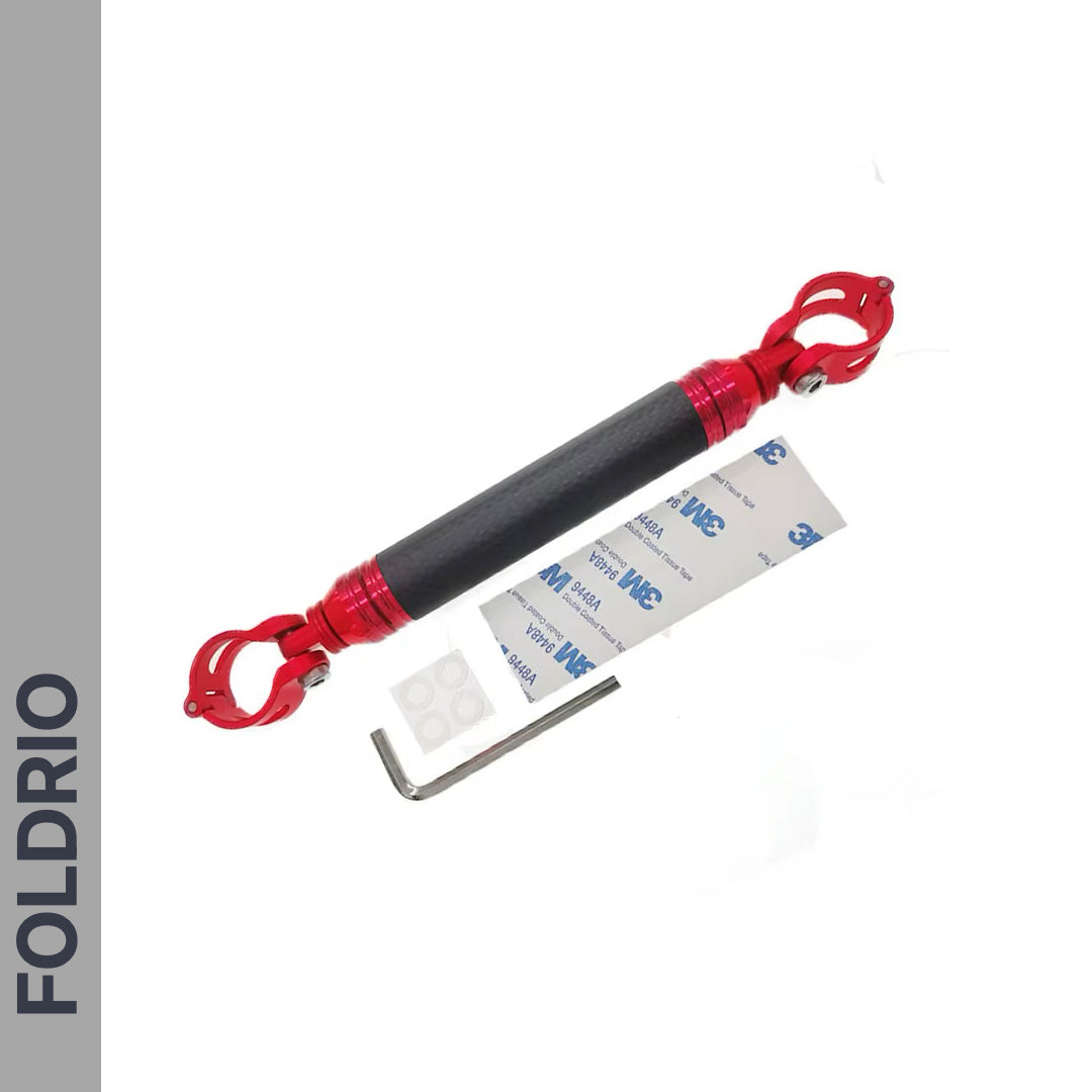 A FOLDRIO Brompton M Handlebar Cross Brace – Adjustable, shown in black and red with clamp ends, L-shaped hex key, adhesive pads, and 3M sticker on a white background. "FOLDRIO" appears vertically on a gray side panel.