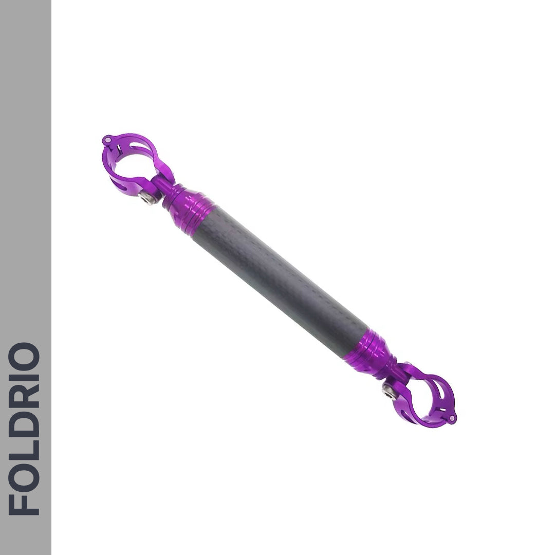 The FOLDRIO Brompton M Handlebar Cross Brace – Adjustable, shown in 6 colours with a carbon fibre look center and purple clamps, is a lightweight handlebar mount displayed on white with FOLDRIO vertically on a gray sidebar.