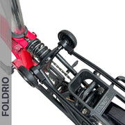 Top view of a folded red Brompton bike highlights the suspension, wheels, FOLDRIO Brompton Rear Rack Elastic Straps (fits AC Line & PT Line), and frame. "FOLDRIO" is shown vertically along the left side.