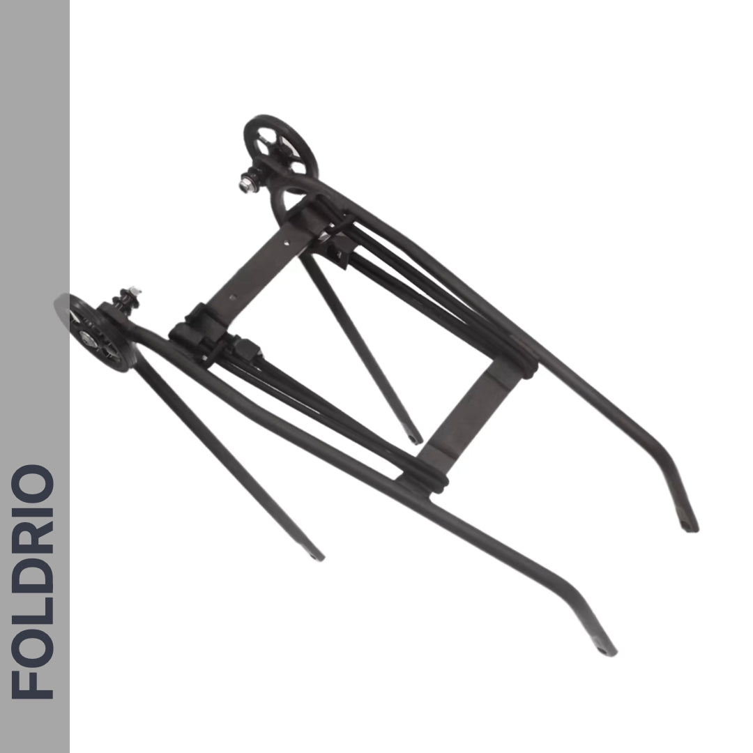 A black metal folding stand with wheels, partially unfolded, on a white background. "FOLDRIO" appears vertically on a gray sidebar—ideal for use with FOLDRIO Brompton Rear Rack Elastic Straps (fits AC Line & PT Line).