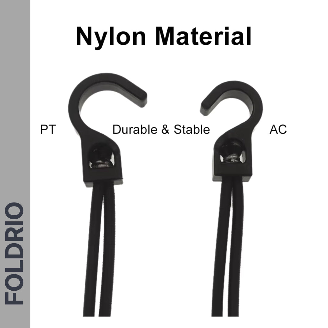 Two black nylon hooks labeled PT and AC are displayed with cords attached. Ideal as Brompton Rear Rack Elastic Straps for AC Line (old) & PT Line (new). "Nylon Material" appears above, "Durable & Stable" below, with a vertical FOLDRIO label on the left.