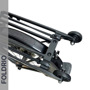 Close-up of a Brompton Rear Rack Elastic Strap by FOLDRIO (fits AC Line & PT Line), securing cargo on a bike with roller wheels for easy movement when folded. The word FOLDRIO appears vertically on the left side of the image.
