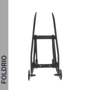 A black folding cart frame with two wheels, shown from the front on a white background. "FOLDRIO" is printed vertically on a gray bar left side. Features Brompton Rear Rack Elastic Straps—fits AC Line (old) & PT Line (new)—for securing your gear.