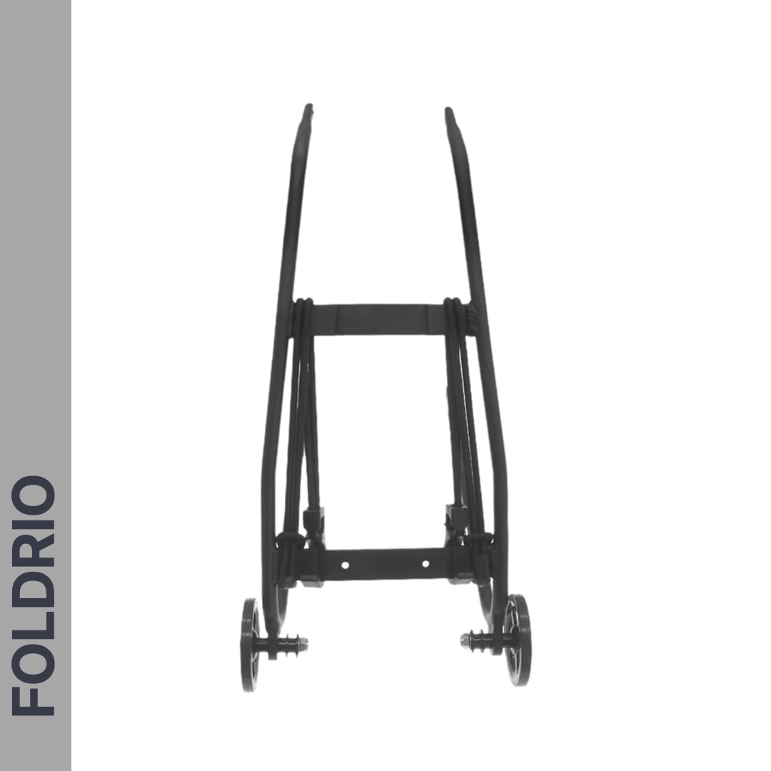A black folding cart frame with two wheels, shown from the front on a white background. "FOLDRIO" is printed vertically on a gray bar left side. Features Brompton Rear Rack Elastic Straps—fits AC Line (old) & PT Line (new)—for securing your gear.