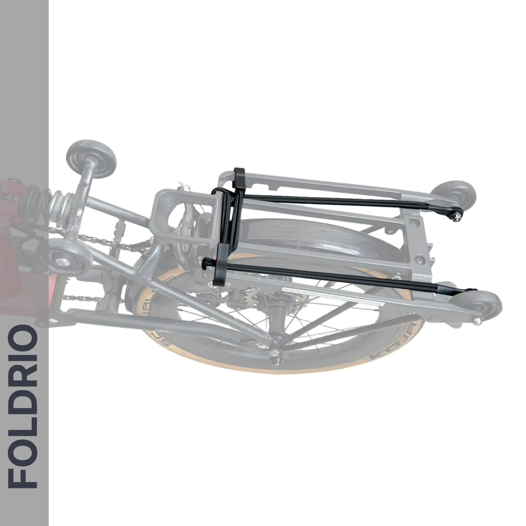 Top view of a folded bike featuring FOLDRIO Brompton Rear Rack Elastic Straps (fits AC Line & PT Line), with the brand name FOLDRIO displayed vertically on the left side.
