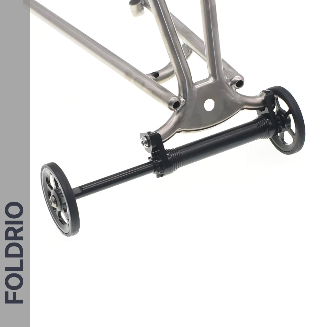 Brompton Brompton Easy Wheel & Extension Rod Set featuring black CNC-machined alloy wheels, metallic frame, “FOLDRIO” on gray bar | Foldrio. Foldrio