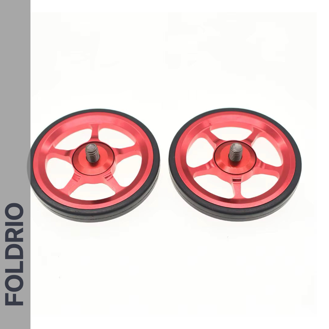 Brompton Brompton red alloy Easy Wheels with black rubber edges and central bolts on white, FOLDRIO branding visible | Foldrio. Foldrio
