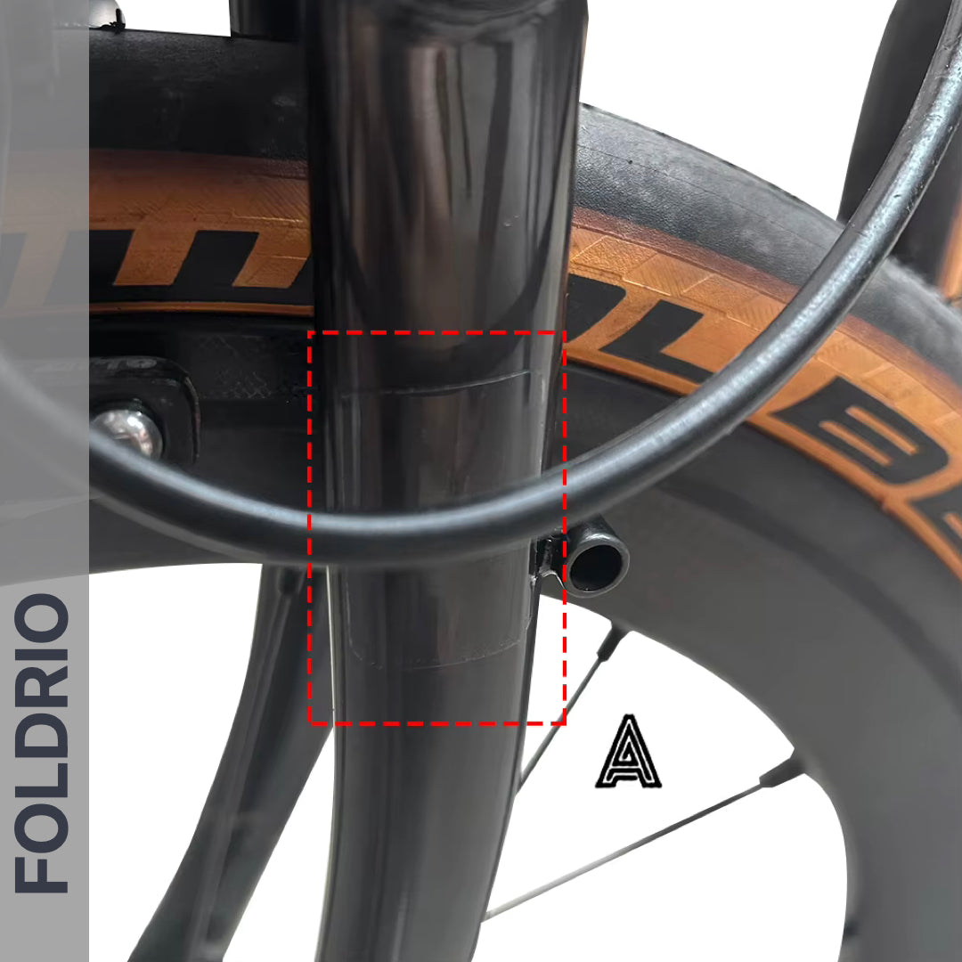 Brompton Brompton front fork and wheel with tan sidewall tire; red dashed box marks ideal spot for Foldrio protective sticker set | Foldrio. Foldrio