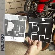 Brompton Brompton Full Frame Film protective stickers, labeled for easy application, held beside a red bike’s front wheel | Foldrio. Foldrio