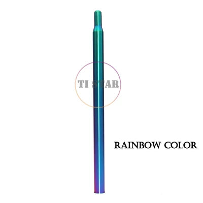 A slim, cylindrical Brompton Titanium Seatpost – Multicolour Edition by FOLDRIO with a gradient rainbow finish stands vertically on a white background. The text "RAINBOW COLOR" is displayed to its right.